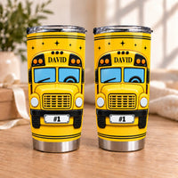 Two personalized school bus driver tumblers featuring the name DAVID and a #1 license plate on a wooden table.