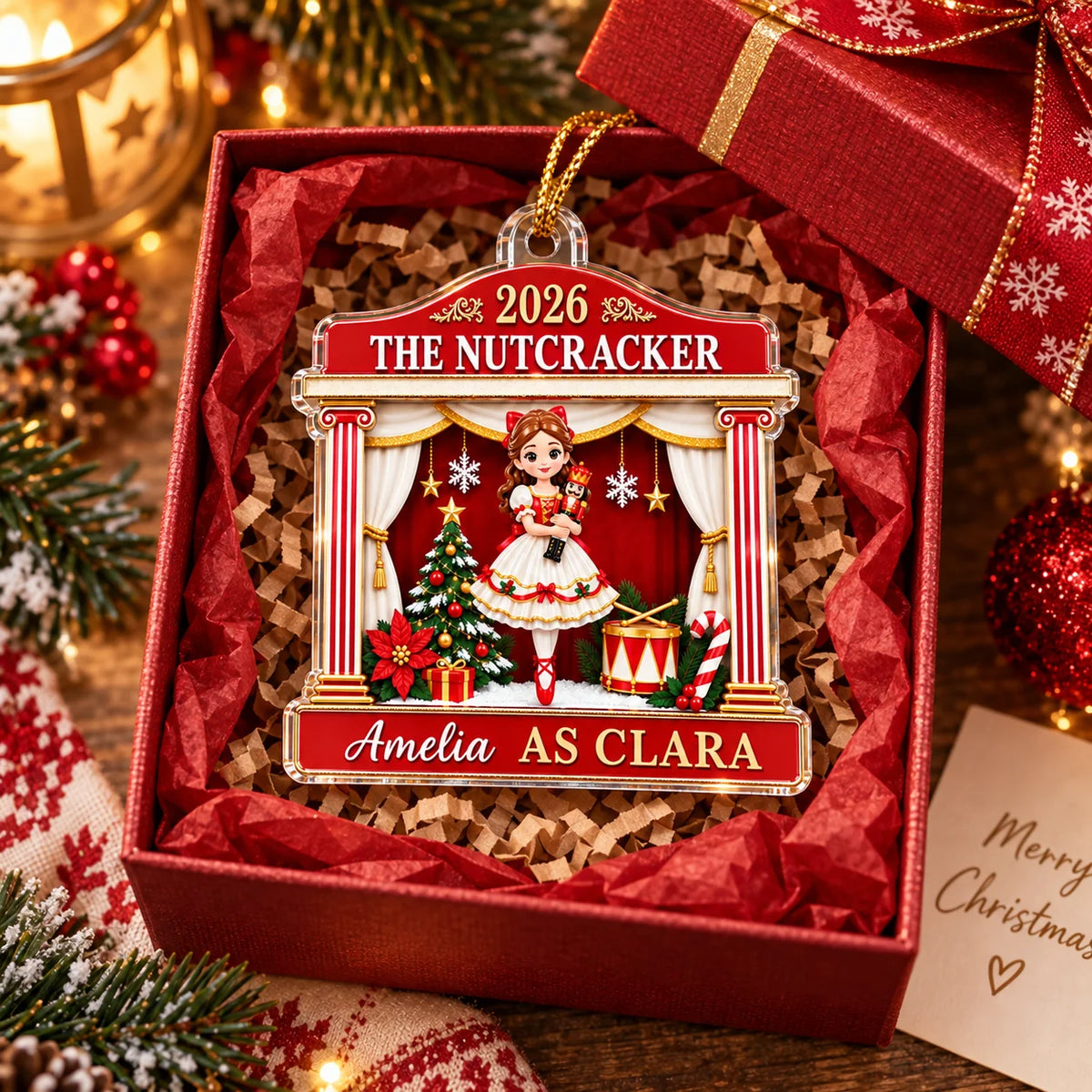 A red 2026 The Nutcracker Personalized Acrylic Christmas Ornament featuring Clara inside a gift box filled with crinkled red