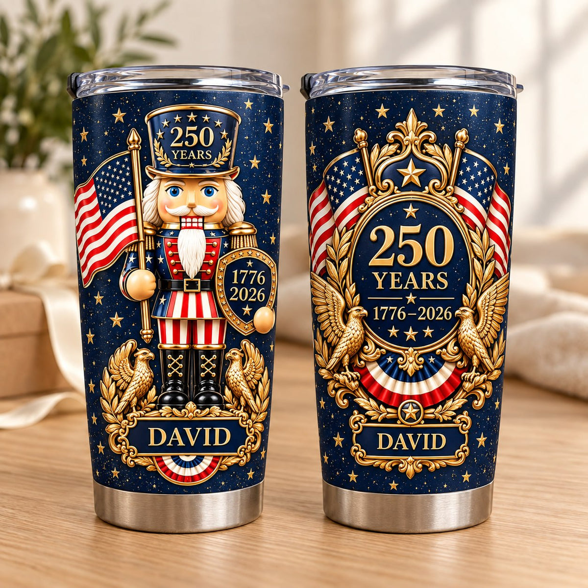 Two stainless steel travel mugs showing front nutcracker graphic and back 250 years anniversary design with custom name.