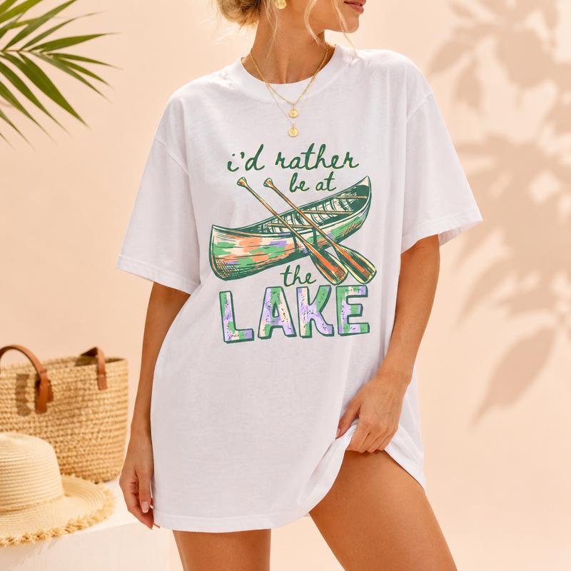 I'd Rather Be At The Lake Shirt Graphic T-Shirt For Lake Day Girl Trip Preppy Lakecore Granola Girl Oversized Fit Crew Neck With Green Purple Canoe Illustration Typography Print Retro Summer Vacation Boating Tee.