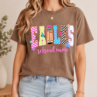 A woman wearing a brown t-shirt featuring a playful retro school text graphic.