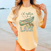 I'd Rather Be At The Lake Shirt Graphic T-Shirt For Lake Day Girl Trip Preppy Lakecore Granola Girl Oversized Fit Crew Neck With Green Purple Canoe Illustration Typography Print Retro Summer Vacation Boating Tee.