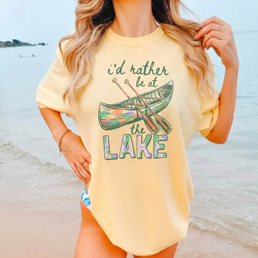 I'd Rather Be At The Lake Shirt Graphic T-Shirt For Lake Day Girl Trip Preppy Lakecore Granola Girl Oversized Fit Crew Neck With Green Purple Canoe Illustration Typography Print Retro Summer Vacation Boating Tee.