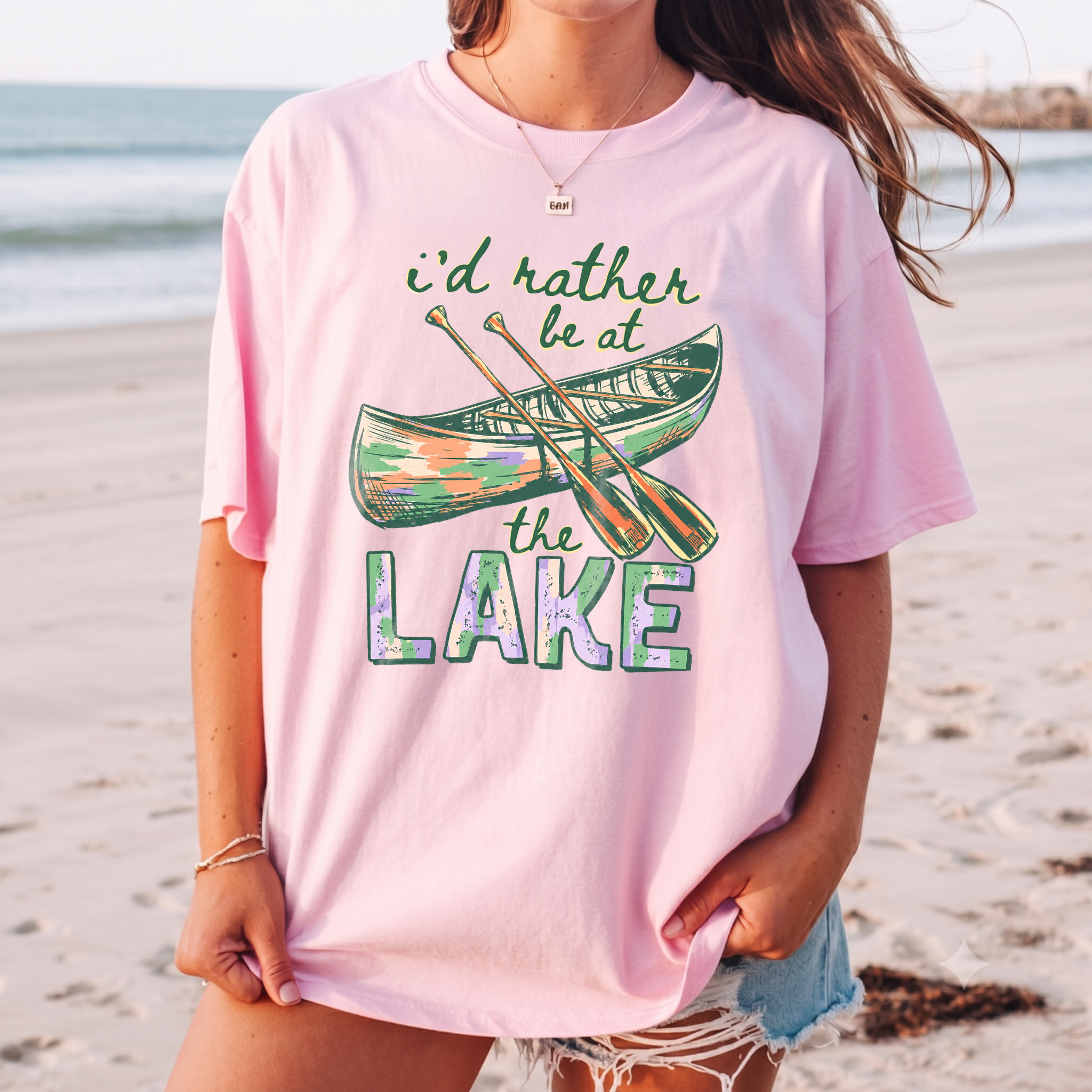 I'd Rather Be At The Lake Shirt Graphic T-Shirt For Lake Day Girl Trip Preppy Lakecore Granola Girl Oversized Fit Crew Neck With Green Purple Canoe Illustration Typography Print Retro Summer Vacation Boating Tee.