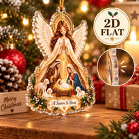 Close-up of the A Savior Is Born angel ornament showing its 2D flat acrylic profile and side thickness on a wooden