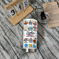 A Year to Remember Tumbler with lid on wood surface next to calendar and menu.