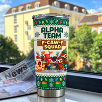 Green stainless steel tumbler with funny chicken graphic displayed on a windowsill with a newspaper.