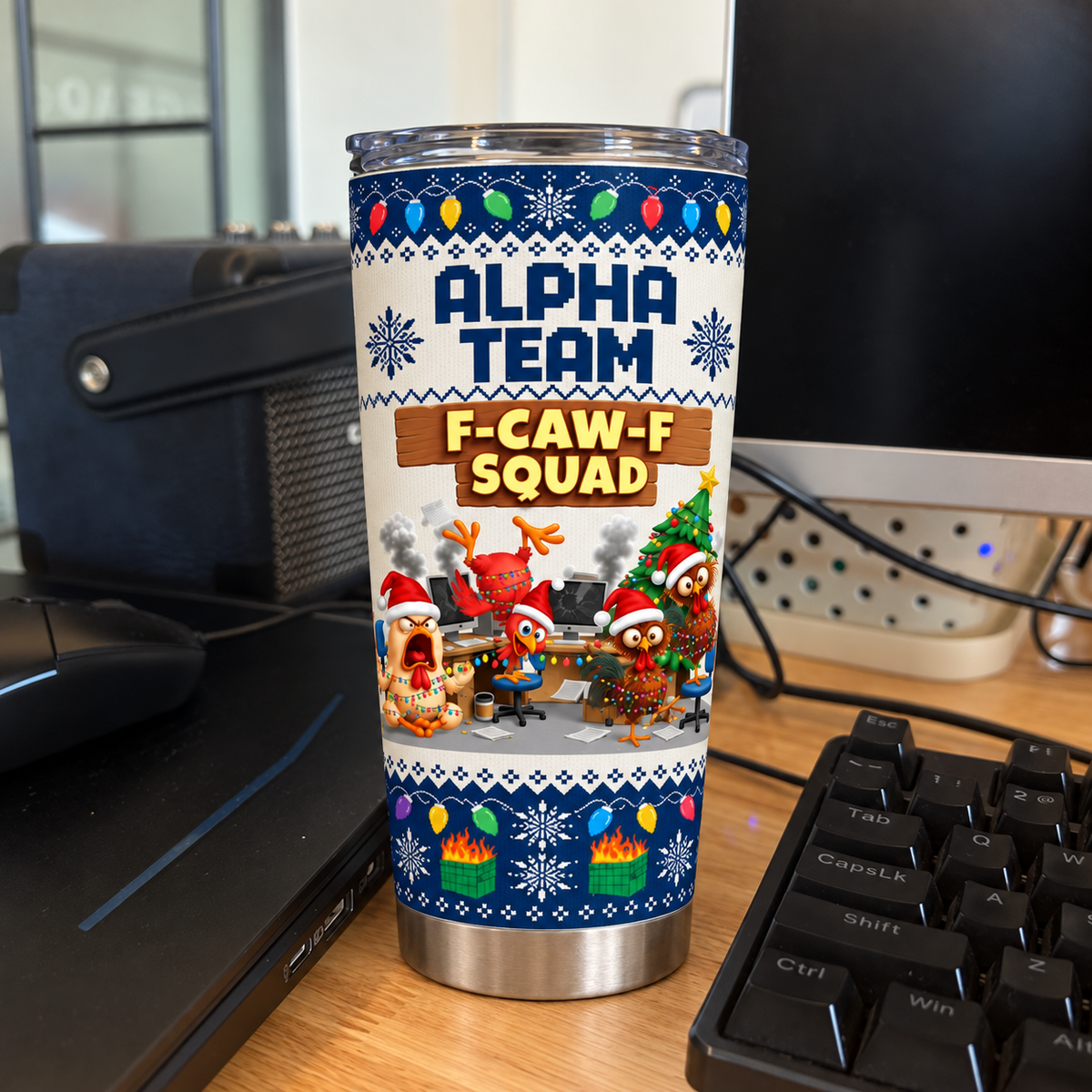 Stainless steel tumbler with holiday chicken print standing on a desk next to a computer keyboard.