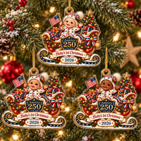 Three America 250 baby's first Christmas ornaments hanging on a glowing holiday tree with festive red and gold decorations.