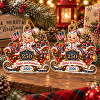 Two America 250 baby's first Christmas ornaments displayed side by side against a warm, twinkling Christmas tree background.