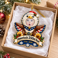 Custom baby photo eagle ornament nestled in an open gift box with tissue paper.