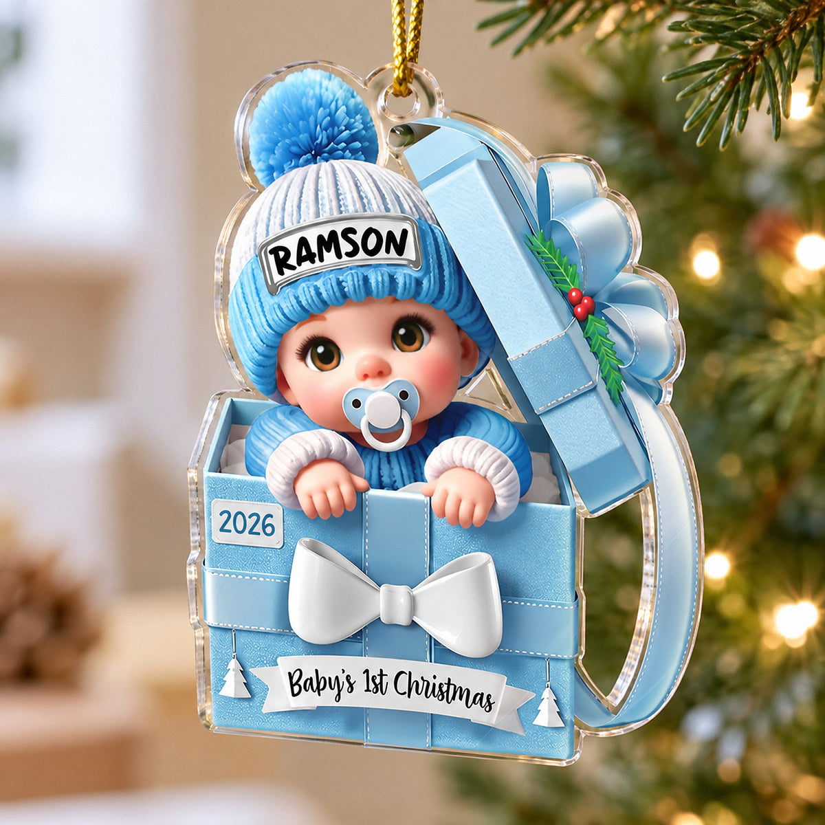 Baby's 1st Christmas ornament in light blue acrylic, shaped like a number one, hanging on a tree.