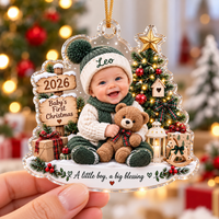 Hand holding the clear acrylic Baby's First Christmas Ornament Personalized for a baby boy with green knit hat.