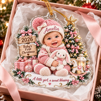 Personalized baby girl acrylic ornament packaged in a pink gift box lined with white tissue paper.