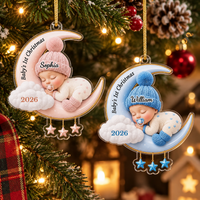 Baby's First Christmas ornament personalized with names Sophia and William, hanging on a decorated tree.