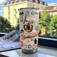 A personalized baker gift stainless steel tumbler with 3D stand mixer design standing near a newspaper on a windowsill.