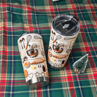 Two cream-colored custom name tumblers with 3D mixer design resting on a red and green plaid fabric next to a mini tree.