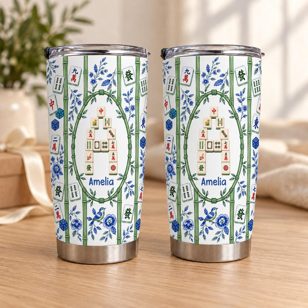 Two bamboo mahjong tile pattern tumblers display custom names inside oval frames against a light backdrop.