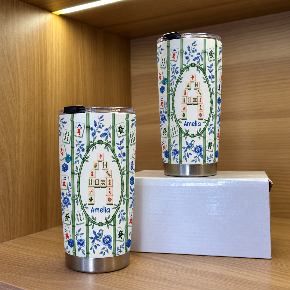 Two bamboo mahjong tile pattern tumblers in different sizes displayed on a wooden shelf.