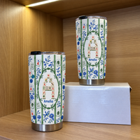 Two bamboo mahjong tile pattern tumblers in different sizes displayed on a wooden shelf.