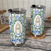 Two personalized mahjong tumblers with bamboo print and blue floral patterns stand on a textured surface.