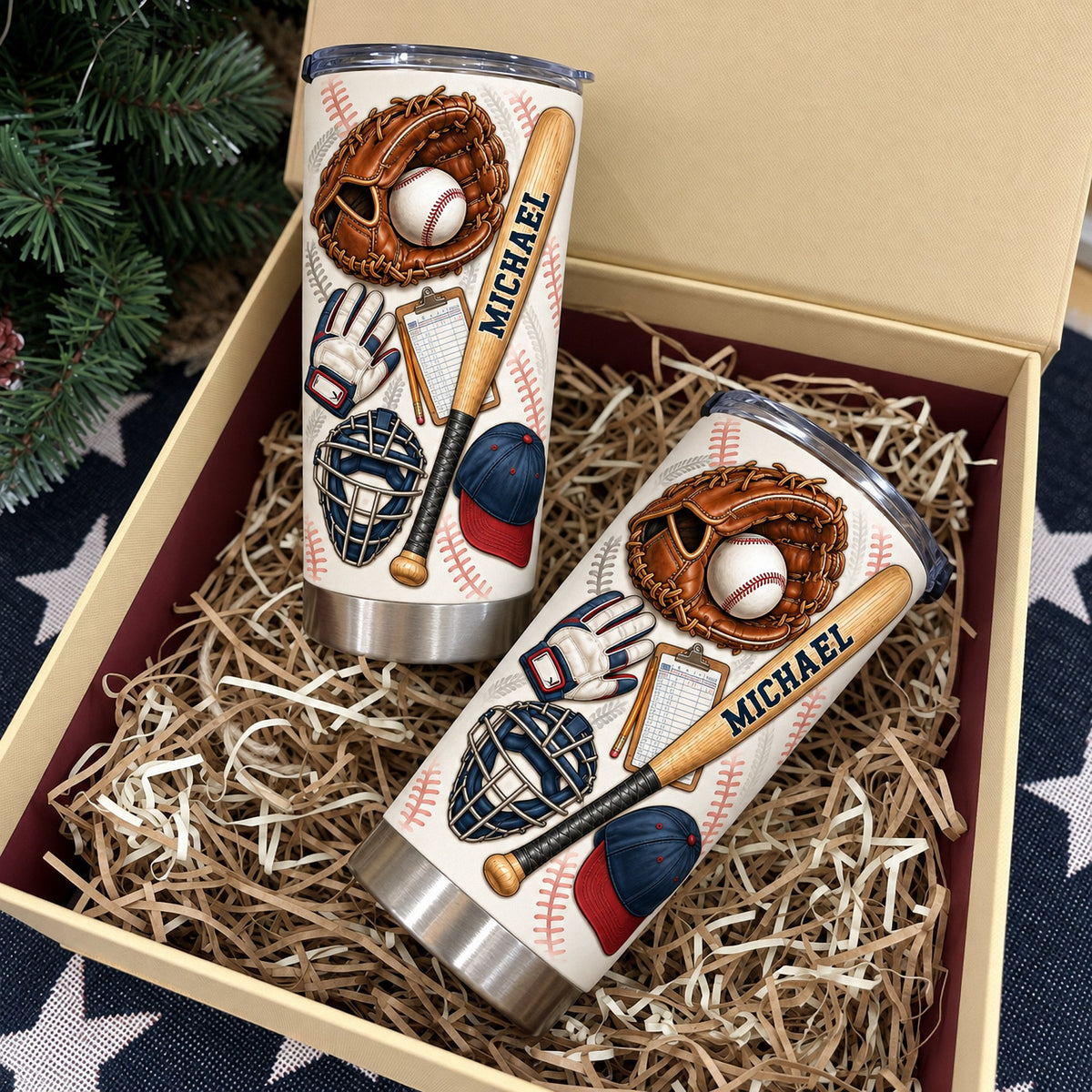 Two personalized baseball cups inside open gift box filled with paper shred