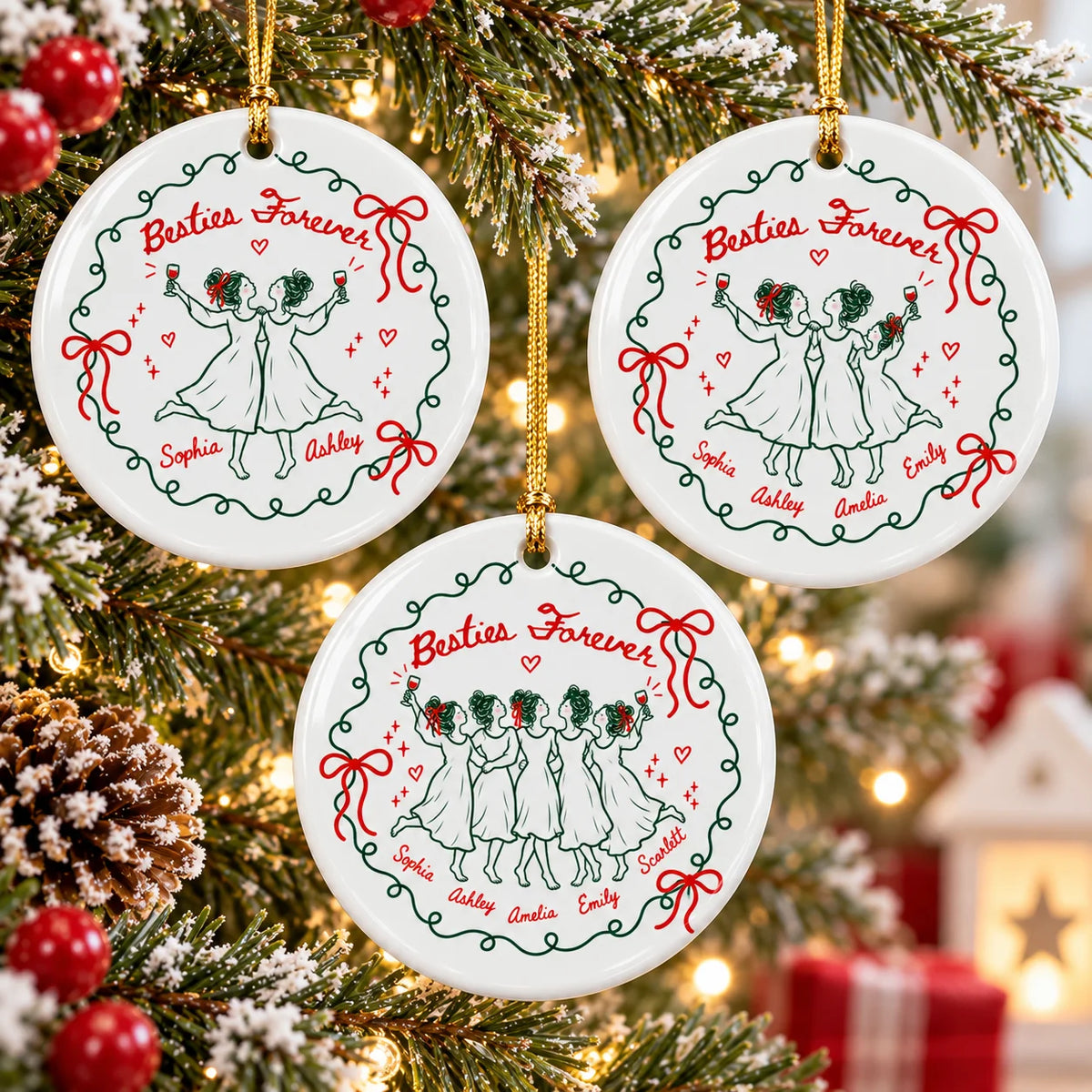 Three round ceramic Christmas ornaments hanging on a pine tree showing custom names and line art of women with wine glasses.