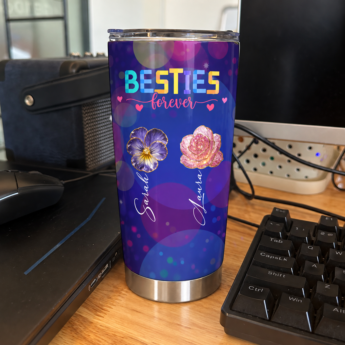 Custom insulated tumbler with purple galaxy bokeh print and floral design displayed on a desk next to keyboard and mouse