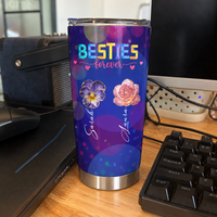 Custom insulated tumbler with purple galaxy bokeh print and floral design displayed on a desk next to keyboard and mouse
