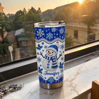 Stainless steel winter tumbler on marble windowsill with sunset view.