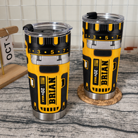 Drill theme stainless steel insulated cups with name BRIAN on a textured surface with a calendar showing OCT in the