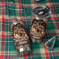 Two custom name rodeo tumblers laid out on a green plaid blanket next to a small decorative miniature pine tree.