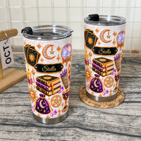 Two personalized celestial witch tumblers displayed on a rustic wood surface.