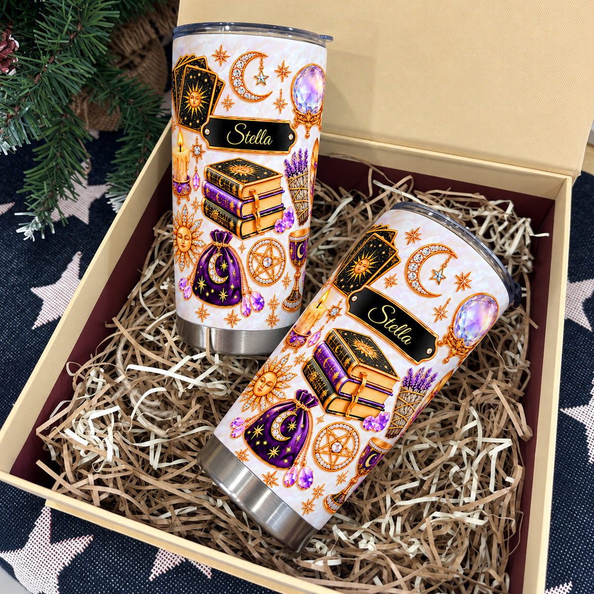 Two personalized celestial witch tumblers nestled in a gift box with straw.