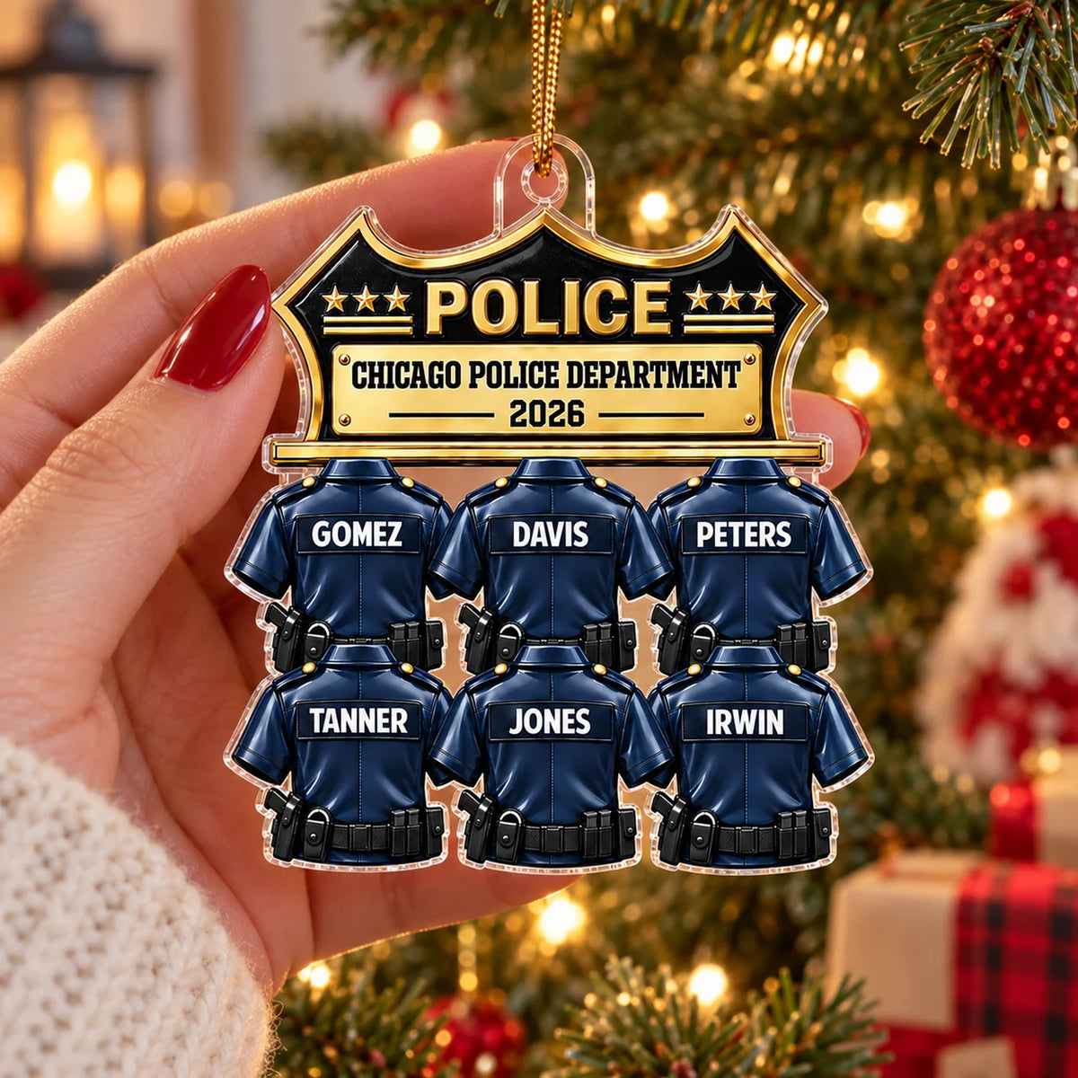 A hand holding a custom Chicago Police Department ornament in front of a softly lit Christmas tree.