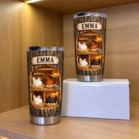 Two stainless steel tumblers with chicken coop graphic and wooden nameplate standing on a shelf.