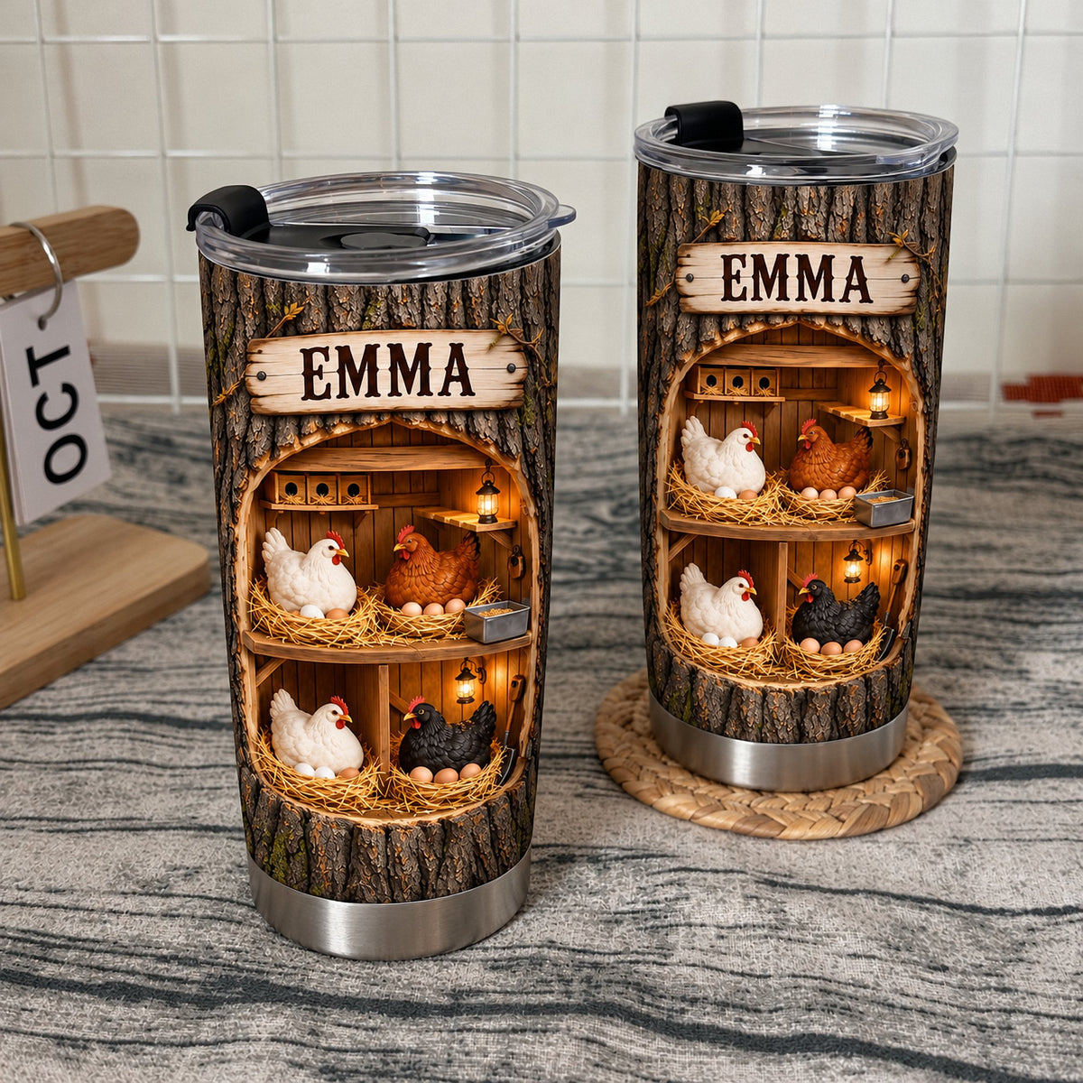 Rustic farmhouse tumbler with hens and eggs graphic placed on a textured surface next to a calendar.