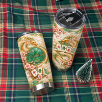 Two custom stainless steel travel cups displayed on a green plaid tablecloth next to a mini tree.