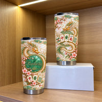 Two Chinese Dragon Mahjong Jade Tumblers displayed together on a wooden shelf with a white gift box.