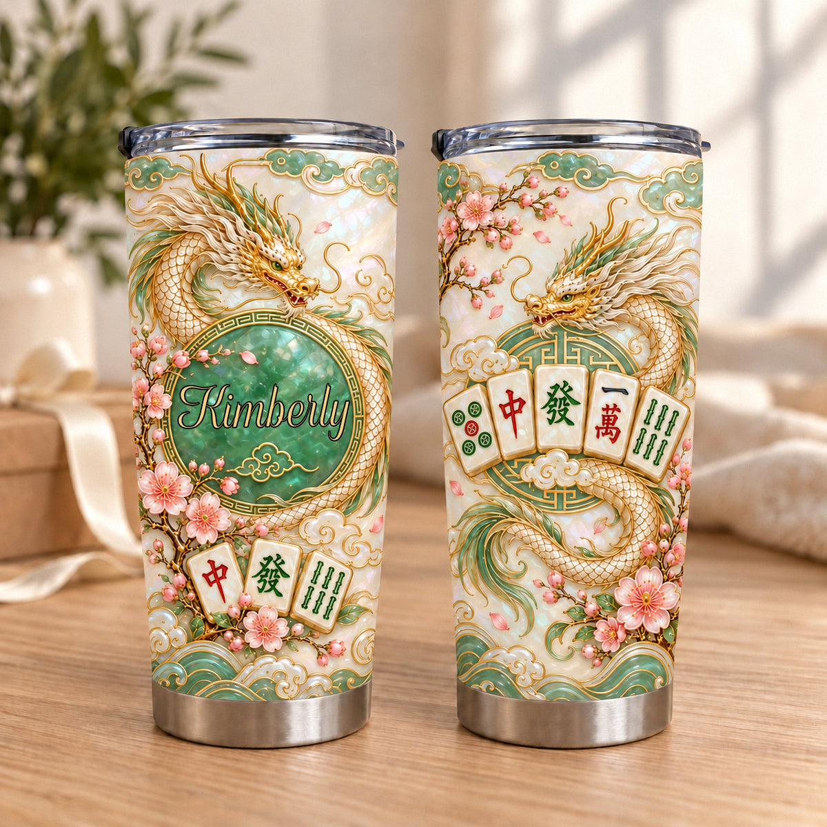 Two stainless steel travel tumblers with gold dragon, pink cherry blossoms, jade circle showing name Kimberly, and Mahjong