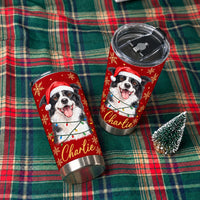 Two red stainless steel tumblers with a Christmas Border Collie design displayed on a plaid blanket next to a mini tree.