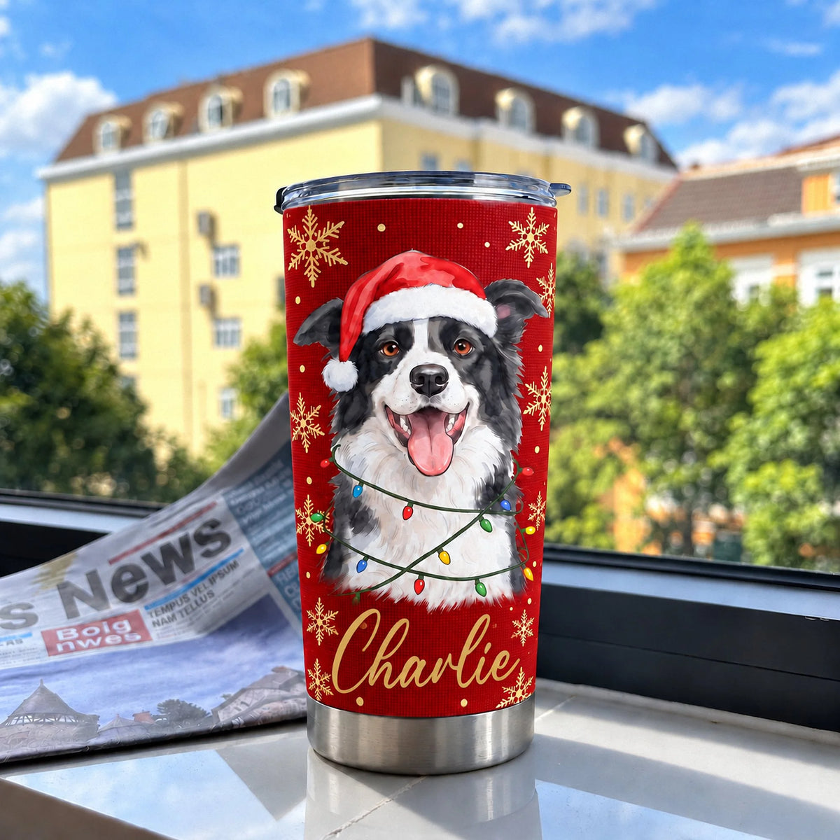 A red stainless steel tumbler with a custom Border Collie art graphic set against a blurred building and sky background.