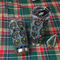 Two cockpit instrument panel tumblers displayed on a green and red plaid fabric next to a mini tree.
