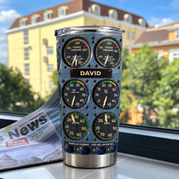 Cockpit instrument panel tumbler with custom name David standing upright on a windowsill overlooking buildings.
