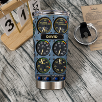 Cockpit instrument panel tumbler with custom name David and its detached lid on a wooden tabletop with a calendar.