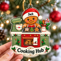 Personalized gingerbread kitchen Christmas gift acrylic ornament with the name Jack hanging on a tree.