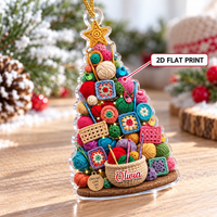Personalized acrylic Christmas tree ornament highlighting a 2D flat print design with colorful yarn balls and a custom name.