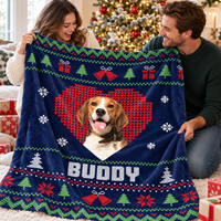Couple holding a navy blue custom pet photo holiday blanket near a tree.