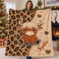 A woman holding up a brown highland cow leopard print blanket in a holiday living room.