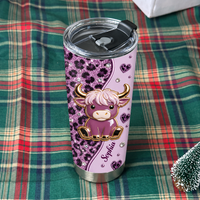 Single 20oz stainless steel tumbler with a cute cartoon highland cow and custom name, displayed on a holiday plaid blanket